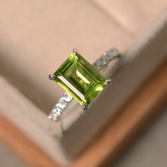 This ring features a 7*9mm natural peridot and sterling silver finished with rhodium. Customization is available. It is made by hand, and it will take about 7 days to finish the ring after your payment is completed. Any question, just let me know. :) My shop homepage: https://www.etsy.com/shop/LuoJewelry?ref=l2-shopheader-name Birthstone Wedding Band, Peridot Engagement Ring, Jewlery Rings, Peridot Engagement Rings, Silver Jewelry Diy, Peridot Jewelry, Emerald Cut Rings, August Birthstone, Diy Rings