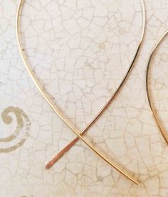 Lightweight loop cross over threader hoop earrings made of 14k gold filled wire. The unique cross over design with one end hammered makes it easy to thread through your ear using the smaller tail. Cute for everyday wear and elegant for your evening nights out too. Each hoop pictured measures 2 inches long by 1 1/2 inches wide. Fish tails extend 1/2 inch to 1 inch long. Fish threader hoops available in 14k yellow gold filled, 14k rose gold filled, Sterling Silver, and 14k Solid Gold. 14k Solid Go Gold Hoop Threader Earrings For Gift, Gold Wrap Earrings With 14k Gold Filled Ear Wire, 14k Gold-filled Wrap Earrings With Ear Wire, 14k Gold Filled Wrap Earrings With Ear Wire, Gold Dainty Wrap Earrings, Adjustable Gold Jewelry With Fish Hook, Minimalist Wire Wrapped Yellow Gold Hoop Earrings, Minimalist Yellow Gold Wire Wrapped Hoop Earrings, Delicate Gold Wire Wrapped Hoop Earrings