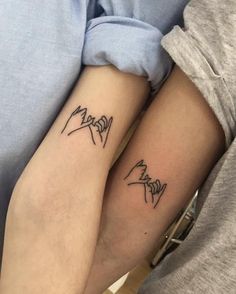 two people with matching tattoos on their arms