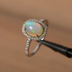 It is a natural opal ring. The main stone is 7mm*9mm oval white opal. The basic metal is sterling silver and plated with rhodium. To change the metal to a solid gold (white/rose) or platinum is also available, please ask for a quotation if you want. You can also go to my shop Home for more elegant rings: https://www.etsy.com/shop/godjewelry?ref=hdr_shop_menu Opal is the birthstone of October, it will be a great gift for your lover! Customization is always welcome and please feel free to contact Oval Opal Rings With Polished Finish, Ethiopian Opal Oval Ring For Wedding, Oval Cabochon Opal Ring In White Gold, Oval Cabochon White Gold Opal Ring, Ethiopian Opal Oval Rings For Anniversary, Oval White Gold Opal Cabochon Ring, Elegant Ethiopian Opal Oval Rings, Oval Ethiopian Opal Ring For Anniversary, Oval Ethiopian Opal Anniversary Jewelry