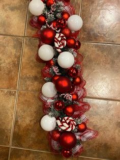 red and white christmas decorations on a tile floor