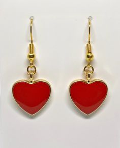 Beautiful red heart shaped earrings perfect for any occasion. Red Drop Earrings For Valentine's Day, Valentine's Day Heart Detail Earrings, Heart Detail Double Heart Earrings For Gift, Gift Double Heart Detail Earrings, Trendy Earrings For Valentine's Day Gift, Trendy Valentine's Day Earrings For Gift, Trendy Valentine's Day Gift Earrings, Heart-shaped Earrings With Heart Detail As Gift, Trendy Heart Charm Earrings As Gift