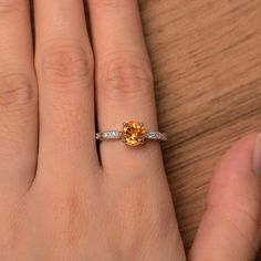 It is a natural citrine ring. The main stone is 7mm*7mm round cut, weight about 1.40 carats. The basic metal is sterling silver and plated with rhodium. To change the metal to a solid gold (white/rose) or platinum is also available, please ask for a quotation if you want. You can also go to my shop Home for more elegant rings: https://www.etsy.com/shop/godjewelry?ref=hdr_shop_menu Peridot is August birthstone Customization is always welcome and please feel free to contact with me if you have any Yellow Stone Ring, Gem Engagement Rings, Yellow Stone Rings, Elegant Rings, November Birthstone Ring, August Birthstone, Yellow Stone, Citrine Ring, November Birthstone