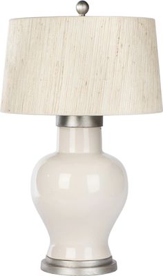 a white table lamp with a beige shade