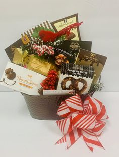 a gift basket filled with chocolates, candy and other holiday treats for someone's special occasion