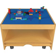 a wooden toy table with legos on it