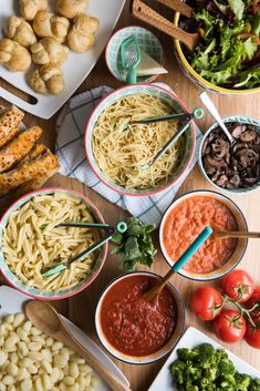 bowls of pasta and vegetables on a table