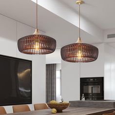 two lights hanging from the ceiling above a dining table