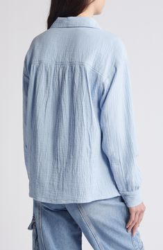 This all-cotton button-up shirt is subtly textured to give off casual vibes. 28" length (size 8) Front button closure Spread collar Long sleeves 100% cotton Machine wash, line dry Imported Long Sleeve Tops With Crinkle Texture For Daywear, Daywear Long Sleeve Tops With Crinkle Texture, Long Sleeve Summer Tops With Crinkle Texture, Summer Long Sleeve Tops With Crinkle Texture, Long Sleeve Cotton Blouse With Crinkle Texture, Cotton Long Sleeve Blouse With Crinkle Texture, Light Blue Casual Top With Button Cuffs, Casual Light Blue Tops With Button Cuffs, Casual Solid Tops With Crinkle Texture