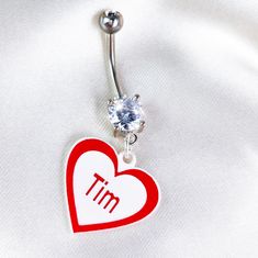 Product Details Take your holiday spirit and gift giving to the next level when you personalize this red and white Valentine's day heart belly ring. This personalized belly ring is made with a 14 gauge surgical grade stainless steel curved barbell and features a festive red and white Valentine's heart dangle charm that can fit your personal message (up to six characters). Custom navel jewelry is a unique gift idea that preserves the initials or short message that is special to you or someone you Silver Belly Rings For Valentine's Day, Valentine's Day Gift Silver Belly Rings, Hypoallergenic Stainless Steel Belly Rings As Gifts, Valentines Day Heart, Navel Jewelry, Dangle Belly Rings, Short Messages, Short Message, Belly Ring