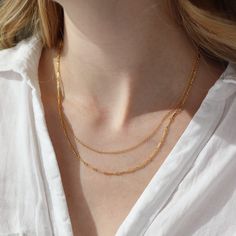 The Equinox Double Chain necklace instantly gives a pretty layered look. This layering necklace features two chains that come together to create a subtle statement, no untangling required. DETAILSAvailable in 14"- 15", 16"-17", and 18"-19" with longer chain measuring an additional 1" in lengthAvailable in 14k Gold Fill and Sterling SilverHypoallergenic, Nickel-Free, and Water Safe Minimalist Satellite Chain Necklace For Layering, Classic Double Chain Necklace For Layering, Minimalist Chain Necklace With Delicate Chain For Layering, Minimalist Cable Chain Necklace For Layering, Double Strand Cable Chain Necklace For Layering, Gold Plated Figaro Chain Necklace For Layering, Minimalist Double Chain Layered Necklace For Everyday, Delicate Cable Chain Necklace For Layering, Delicate Double Chain Necklace For Everyday