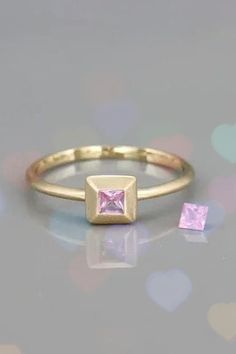 Natural Gemston Ring. Pink Sapphire Solitarie Ring, solid 14k gold princess cut pink sapphire Ring, Pink Gemstone ring. This ring is a dainty yet gorgeous pink sapphire ring. The ring was designed so the bezel looks like a crown for the stone extending it and enhancing its natural beauty. You can wear the ring on its own or to stack it with other rings from my collection. This ring will add a stylish luxury touch to your look. Pink Gemstone Ring, Art Jewelry Design, Princess Cut Gold, Pink Sapphire Ring, Gemstone Jewelry Handmade, Pink Gemstones, 14k Gold Ring, Pink Sapphire, Princess Cut