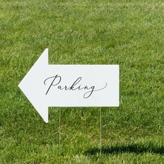 a sign that is in the grass with a wedding date on it's side