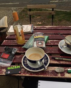 a cup of coffee sitting on top of a wooden table