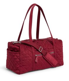 Vera Bradley's Iconic styles are a modern twist on their classic silhouettes, refreshed with added functionality. This one is crafted in their newest must-have material, water-repellent performance twill. Going home for the weekend or out for an overnight getaway? This duffel will help you pack it all in style. Dimensions: 20"W x 10"H x 10"D with 15" strap drop 52.5" removable, adjustable strap Performance twill is made from quilted, sleek, water-repellent polyester Exterior features one zip and Large Capacity Burgundy Travel Bag, Red Travel Bag With Adjustable Strap, Red Large Capacity Gym Bag For Travel, Red Travel Bag With Zipper For Daily Use, Large Capacity Red Gym Bag For Travel, Red Travel Bag With Zipper Closure For Daily Use, Functional Red Duffle Bag For Travel, Red Functional Bag With Luggage Sleeve, Red Rectangular Gym Bag For Travel