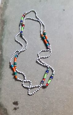 Multi-colored beaded long statement Lariat necklace. This white and multi seed beads extra long necklace looks vibrant and colorful. Wear the necklace as long lariat or in multiple folds.  Length - Approx. 60 inches.(Drop length 30")  * The products are handmade and shipped from India. * Package preparation time is 1 - 2 business days. * Standard shipping - Transit time approx. 12 - 24 business days. * Express shipping - Transit time is 3-7 days worldwide.  * All kind of taxes, custom duties, VAT etc will be borne by the buyer as I am not responsible for the same. * Do write to me if any query. I shall revert ASAP * For refund and returns please refer to our policies. Back to store - https://www.etsy.com/your/shops/GangesIndiSoul Extra Long Necklace, Long Statement Necklace, Funky Jewelry, Lariat Necklace, Seed Bead, Chain Styles, Extra Long, Long Necklace, Multi Colored