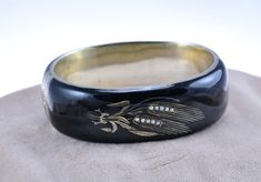 Today I have an antique, unique bangle for you. The bracelet is made of  silver 750 (a typical alloy for items from the 19th century). The whole piece is covered with black enamel. The bracelet is finely decorated, engraved. On the front, an ear of grain motif, decorated with seeds pearls. The bracelet is very impressive. It consists of two half hoops on a hinge, box clasp (works fine).  The bracelet has hallmarks of the Austro-Hungarian Empire - Vienna 1872-1922 and the author's namesake. The o Vintage Black Enamel Bracelet, Vintage Black Enamel Bracelet Jewelry, Vintage Black Enamel Bracelets For Formal Occasion, Traditional Engraved Bangle For Formal Occasions, Traditional Black Engraved Bracelets, Victorian Style Bangle As A Gift, Vintage Carved Bracelets For Ceremonial Occasions, Traditional Black Bangle Gift, Vintage Black Bracelet For Wedding