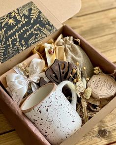 a box filled with lots of different types of items on top of a wooden table