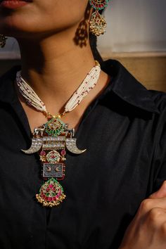 Dual toned necklace handcrafted in vintage, reindeer cut work motifs, carved work, layered pearl chains, multi color kundan, stone, bead embellishment and pearl drop tassels. Paired with embellished dangler earrings.
Type: Carved Work, Kundan and Bead Embellished
Composition: Metal Alloy
Color: Multi Color
Other Details: 
Handcrafted
Dimensions Length (in inch):
Necklace: 6
Earrings: 3
Weight (in gms): 110 - Aza Fashions Traditional Kundan Necklace With Detachable Pendant For Celebrations, Traditional Kundan Necklace With Detachable Pendant For Festive Occasions, Festive Traditional Kundan Necklace With Detachable Pendant, White Necklace With Motifs For Festivals, White Necklace With Motifs For Festive Occasions, White Necklaces With Motifs For Festivals, White Necklaces With Motifs For Festive Occasions, Traditional White Necklace With Detachable Pendant, White Festive Necklace With Motifs