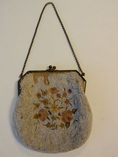 Antique Victorian Beaded Purse Petit Point   This is a beautiful antique beaded and petit point floral embroidered Victorian ladies purse.  This would have been used in the evening and hung on the wrist.  This has white micro beads on both sides.  One side reveals the floral petit point in pink, green and white.  Surrounding the flowers are micro white beads in a swirled pattern.  The opposite side has all micro beads in swirl patterns.  The frame is brass colo Vintage Embellished Pouch Bag, Vintage Embellished Wedding Shoulder Bag, Vintage Embellished Shoulder Bag For Wedding, Vintage Evening Bag With Pearl Embroidery, Vintage Embellished Evening Bag, Vintage Rectangular Bag With Pearl Embroidery, Vintage Beaded Shoulder Bag, Vintage Formal Bag With Pearl Embroidery, Vintage Formal Bags With Pearl Embroidery