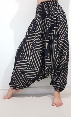 "These super soft rayon baggy unisex harem pants have the \"flow\", perfect of yoga or just a cool strolling. Comfort and character are what these pants are all about. They have the traditional sarong look & feel but a lot more practical when it comes to activity like yoga. As a bonus, they are convertible! Just pull them up and you get yourself a cute jumpsuit in a flash. Together with elastic cuff legs, you can wear them short or long. The pants have smock waist (wide bang elastic) with no Yoga Harem Pants With Elastic Waistband, Relaxed Fit Harem Pants For Meditation, Baggy Harem Yoga Pants For Loungewear, Black Bohemian Harem Pants With Relaxed Fit, Black Bohemian Relaxed Fit Harem Pants, Yoga Harem Pants With Drop Crotch, Yoga Harem Pants With Drop Crotch And Relaxed Fit, Relaxed Fit Drop Crotch Harem Pants For Yoga, Baggy Harem Pants For Meditation