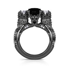 a black diamond engagement ring with skulls on the sides and diamonds in the middle, set against a white background