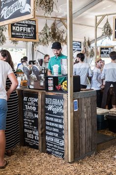 people are standing in line at the food stand