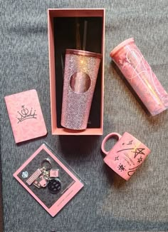 the pink box is filled with items like a cup, watch and keychain