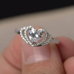 This is a gorgeous handmade creation. Its beauty is its simplicity & Elegance. The 6*6 mm heart cut faceted Cubic Zirconia is crafted in solid sterling silver and with rhodium plated. All item is sent in a beautiful gift box If you have any idea of design your ring,pls contact me directly. You can realize more lovely stuff clicking the link https://www.etsy.com/shop/knightjewelry?refshopsection_shophome_leftnav Please leave the correct address and you phone number for delivering successfully Heart Cut Ring, Heart Shaped Diamond Ring, Heart Shaped Engagement Rings, Rings Heart, Heart Wedding Rings, Cz Rings Engagement, Engagement Ring White Gold, Heart Shaped Rings, Birthday Ring