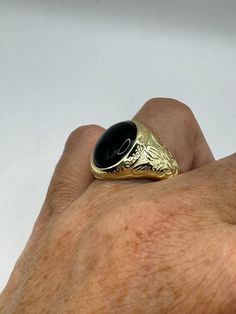 This is a Persian-styled vintage onyx mens ring set in 925 sterling silver accented with 14k gold and a genuine black onyx. This is a gorgeous ring, intricate detail work on the silver set with a beautiful onyx. We have in a sizes 9, 10 11 or 12 this can be sized to your specification, please message us to discuss sizing your ring there is a $20 fee. or engraving options. All of our jewelry is hand polished and shipped to you in a stylish gift box.  We are happy to gift wrap for you.  It is impo Classic Onyx Signet Ring With Polished Finish, Classic Round Signet Ring With Black Enamel, Luxury Hallmarked Onyx Rings, Black Engraved Ring With Polished Finish For Formal Occasions, Formal Black Engraved Ring With Polished Finish, Luxury Black Engraved Ring For Formal Occasions, Gold Onyx Rings With Polished Finish, Formal Black Engraved Ring, Luxury Black Engraved Ring With Polished Finish