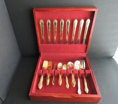 an open red box with silverware in it