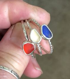 "Handcrafted Sterling Silver Stack Rings with Red, Butter Yellow or Cobalt Blue Sea Glass. These rings have been handmade using 925 Sterling Silver that has been stamped. The settings are pieces of genuine Red, Butter Yellow and Cobalt Blue that are all in Bezel settings and are approximately 1/4\" wide each. These rings cannot be resized and are sold individually. Size 10 1/2 These exquisite pieces feature a shimmering shard of sea glass, delicately set on a high-quality sterling silver band. E Handmade Adjustable Stackable Rings As Gift, Unique Handmade Stackable Rings For Gift, Unique Handmade Stackable Promise Rings, Unique Handmade Stackable Rings As Gift, Unique Adjustable Round Stackable Rings, Unique Handmade Adjustable Stackable Rings, Handmade Artsy Rings As Gifts, Handmade Artsy Rings For Gift, Unique Blue Adjustable Stackable Rings