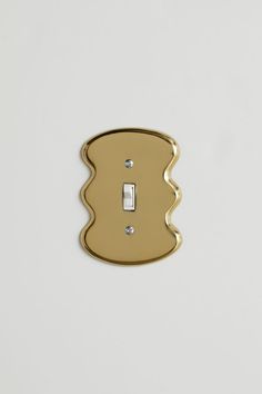 a single light switch cover in gold