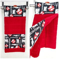 two red towels hanging on the wall next to each other with black and white designs