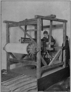 an old black and white photo of two men working on a machine