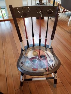 a chair that has been painted with an octopus on the back and sides, sitting in a living room