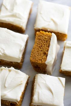 several pieces of carrot cake with white frosting