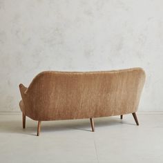 a brown couch sitting on top of a white floor