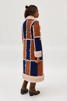 Boho Kimchi Blue jacket in a longline, overcoat silhouette. Designed in a patchwork faux suede featuring a notched collar and statement sherpa trim throughout. Exclusively at Urban Outfitters. Features Kimchi Blue Ember patchwork jacket Faux suede overcoat Patchwork faux suede Faux fur trim throughout Sherpa notched collar and long sleeves with sherpa cuffs Sherpa trim placket and hemline Oversized, relaxed fit Longline length UO exclusive Content + Care 100% Polyester Machine wash Imported Size + Fit Model in Navy + Rust is 5’9" and wearing size Small Measurements taken from size Medium Length: 48" | Kimchi Blue Ember Patchwork Coat Jacket in Navy/Rust, Women's at Urban Outfitters Patchwork Coat, Kimchi Blue Dress, Patchwork Jacket, Kimchi Blue, Notched Collar, Blue Jacket, Fur Trim, Medium Length, Faux Suede