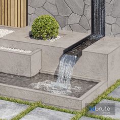 a water fountain in the middle of a garden with rocks and grass around it's edges