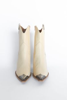 Take your look to the Wild West with the Vannah Western Bootie. This sleek and stylish bootie is the perfect mix of country and sass, featuring a metal toe accent to give you a hint of edge and a chunky heel for a comfy and comfortable fit. Yee-haw! *The off-white is a faux-leather material, the brown is a faux cowhide textured. Both feature an inside zipper for ease of putting them on. These fit true to size and have a 3.5" heel. All sale items are considered final sale. Cream Colored Boots, Cowgirl Era, Mom Vibes, Country Shoes, Mini Boots, Faux Cowhide, Wedding Boots, Heart Shoes, Fall Boots