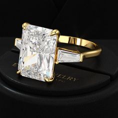 a diamond ring sitting on top of a black box