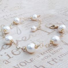 Beautifully polished white cultured pearls create a classic and elegant bracelet for a June born woman since pearl is her traditional birthstone. Genuine natural freshwater pearls are carefully hand wire wrapped with 14k gold filled wire and finished with a gold filled clasp and chain extender for the perfect fit every time.  Give a thoughtful high quality real pearl gift for mom who loves pearls or for your bride who loves dressy classic pearl jewelry. Gorgeous accessory for a little black dres Classic Pearl Drop Bracelet For Wedding, Adjustable Pearl Beaded Bracelets For Anniversary, Classic Wedding Pearl Drop Bracelet, Elegant Pearl Charm Bracelets For Jewelry Making, Elegant Pearl White Beaded Bracelets For Jewelry Making, Elegant Adjustable Pearl Bracelet With Birthstone, Anniversary Pearl Bracelet, Hypoallergenic Beaded Bracelets For Anniversary, Elegant Beaded Bracelets With Birthstone For Wedding