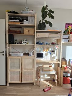 a child's playroom with shelves and toys on the floor in front of it