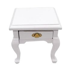 a small white wooden table with gold handles