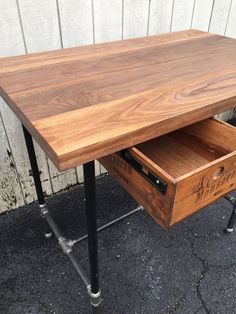 a wooden desk with metal legs and drawers