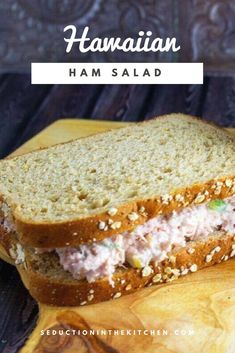 a close up of a sandwich on a cutting board with the words hawaiian ham salad