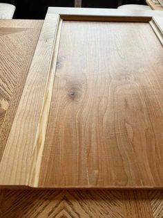 a close up of a wooden frame on top of a table with wood grains