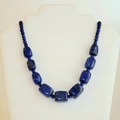 "-  Gorgeous Lapis Lazuli Beaded Gemstone Necklace featuring a Center Focal Point of Large Highly Polished Rectangular Nuggets or Cubes with 6mm and 4mm Rounds Beads and a 925 Sterling Silver Hammered Hook & Eye Clasp. See Photos #1-5. - Lapis Lazuli polished Nuggets are approximately 3/4 x 5/8 x 5/8\" is size, with some variation of course. Highly Polished Round Beads 6 & 4mm.  - Small Silver Twist Heishi Beads provide accent. - Because of the sizable and showy Cube Beads the Necklace weight of the Necklace is 3.8oz. - 20\" Length including the Clasp. - Closure with Bright 925 Sterling Silver Hammered EZ Hook & Eye Clasp. See Photo #6. - We have numerous Lapis Lazuli Matching Hook, Stud and Lever Back Earrings and several Beaded Stretch Bracelets that Match the Necklace, all under separat Cube Beads, Lapis Lazuli Beads, Heishi Beads, Hook Clasp, Hammered Silver, Beaded Stretch Bracelet, Hook Eye, Beautiful Gift Boxes, Beaded Pendant