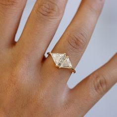 a woman's hand with a yellow gold ring on top of her left hand